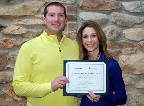 David Smallwood (left) receives his certificate of completion for the Syngenta Business Institute from Stephanie Schwenke (right), the company’s golf market manager.
